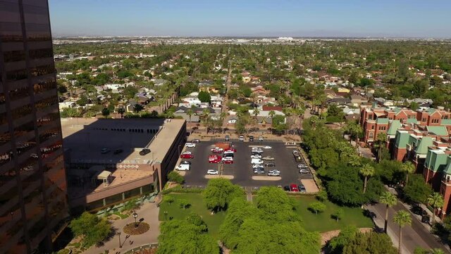 Vehicles Parked At Parking Lot Near BMO Tower Building In City Of Arizona, USA. - aerial