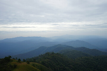 Natural landscape of green mountain range with cloudy blue sky