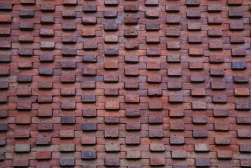 Patterned masonry wall with protruding bricks abstract horizontal background texture