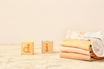 Set of baby clothes and accessories on color background