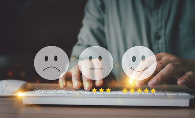 Hand using keyboard with Happy icon and Five stars for service rating feedback of experience customer survey. Business annual satisfaction  concept. Many sad or happily icons, excellent performance.