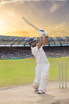 Cricketer batsman hitting a shot