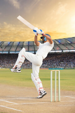 Cricketer batsman hitting a shot