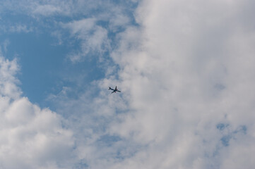 Fototapeta na wymiar In the sky, the plane flies among the clouds
