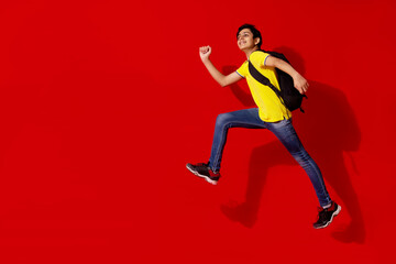 Fototapeta na wymiar A HAPPY TEENAGER POSING WHILE JUMPING