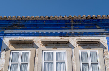 Travel to Portugal. Old vintage facade and window from house exterior in Portuguese typical traditional village or city.