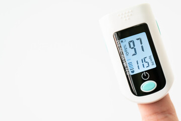 Asian Man measuring oxygen level with modern fingertip pulse oximeter using for measuring heart rate checking oxygen saturation level in the blood diagnosis of Coronavirus or COVID-19 medical concept