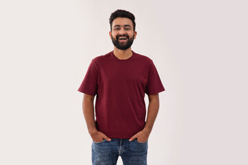 A HAPPY BEARDED MAN STANDING IN FRONT OF CAMERA AND LAUGHING