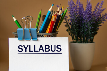 SYLLABUS - word on a white sheet against the background of pencils and a bouquet of lavender