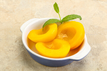 Sweet ripe canned peaches with mint