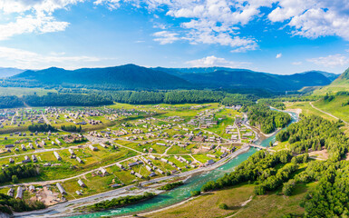 Beautiful Hemu Village with natural scenery in Xinjiang,green mountain and forest with rivers.Hemu Village is a famous travel destination in China.Aerial view.