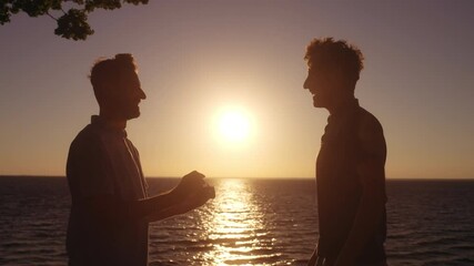 Gay couple engagement at seaside, man in love making proposal to boyfriend