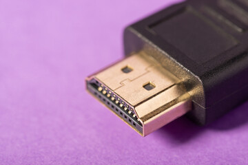 Close-up photo of HDMI cable on violet background. Using fast HDMI port for connecting monitors to...