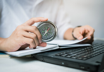 Businessman at the workplace with compass on desk © showcake