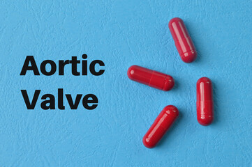 Pill capsules on blue background with text AORTIC VALVE.