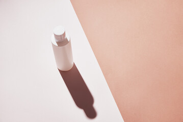 Natural cosmetics mock up. Beauty product concept. White bottle on pastel background