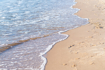 Soft wave of the sea on the sandy beach.Soft focus,blurred image.