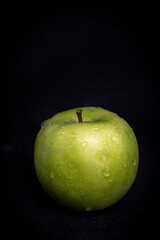 Wet Green Apple on Black Background