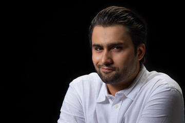 Portrait of a young man with a smirk on his face.