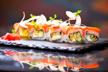 Philadelphia Maki Sushi set with salmon, passion fruit sauce and coconut chips on top. Sushi menu. Japanese food.