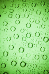 Water bubble on green glass.