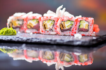 Sushi roll Philadelphia with salmon, tuna, avocado, cream cheese, passion fruit sauce. Sushi menu. Japanese food. © zhinna