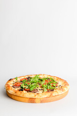 Tasty pizza with meat, mushrooms, tomatoes and basil isolated on white. Copy space banner, vertical banner.