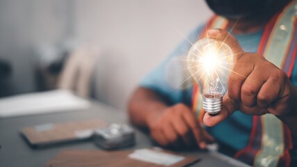 Engineer man hand holding light bulb. idea concept with innovation and inspiration