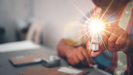 Engineer man hand holding light bulb. idea concept with innovation and inspiration