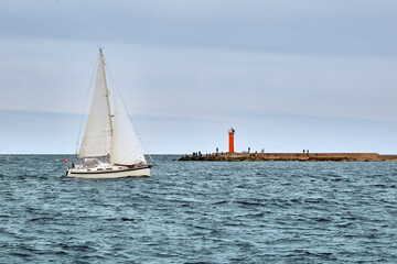 Pleasure boat is sailing from harbor to sea