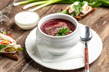 borscht. Traditional bowl of red beet root soup borsch with white cream. Beet Root delicious soup. Ukraine food cuisine. Food recipe background. Close up