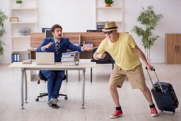 Old boss and young male employee in summer vacation concept