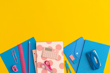 School stationery on a yellow background. Top view with copy space. Flat lay. Back to school concept.