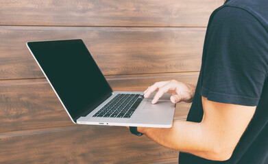 Fototapeta premium Man has stopped and checking mail near the brown wall