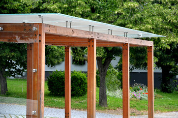 wooden structure of the bus stop, the shelter of the gazebo pergola. the roof and walls are lined...