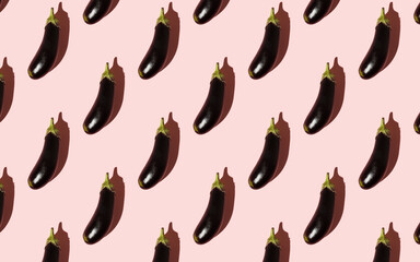 Pattern of eggplants isolated on light pink background. Abstract vegetable texture with summer shadows. Creative food concept. Healthy food style, vegetarian collage. Flat lay, top view.