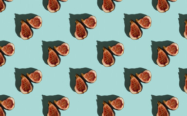 Colorful fruit pattern of fresh figs on blue pastel background, top view, flat lay. Sliced figs pattern in hard light