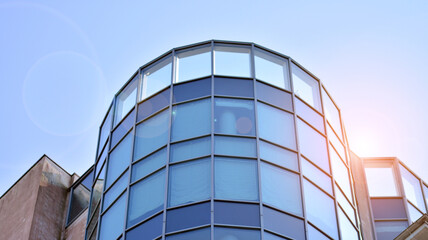 Abstract image of the facade of a modern apartment building covered in reflective plates and glass.