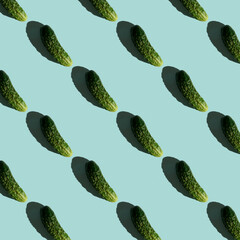 Fresh cucumbers on a blue background. Pattern of cucumbers. Top view. Banner. Pop art design, creative summer food concept. Green cucumbers, minimal flat lay style.