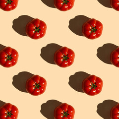Red tomatoes pattern on a pastel pink background, flat lay. Tomato wallpaper, vegetable pattern, pop art composition.Top view. 