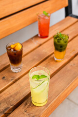 A variety of refreshing summer iced lemonades: espresso tonic, matcha tonic, ginger and pineapple, raspberry and passion fruit. Served in highball glasses.