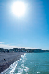Landscape with white beach, the sea and the beautiful sun in the blue sky. High quality photo