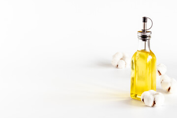 Cotton seeds oil with plant flowers. Essence extra virgin oil