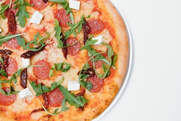 Delicious italian pizza over white background top view