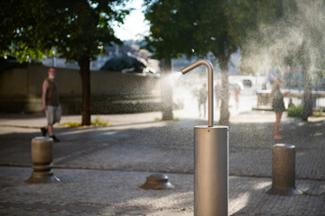 Mist machine installed on a public place to cool down the air. Equipment helps lowering the heat...