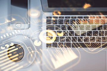 Technology hologram drawing over computer on the desktop background. Top view. Double exposure. Tech concept.