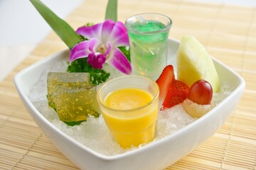 cold sweet dessert platter with pudding, mango, fruits, deep fried red bean paste, jelly, strawberry, watermelon, almond, longan, lychee in white background asian halal menu
