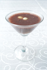 chilled red bean paste soup in cocktail glass in white background asian halal menu