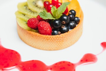 Delicious cheesecake with berries on table close up