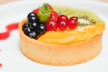 Delicious cheesecake with berries on table close up